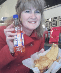 Christina Conte holding Irn Bru bottle with fish and chips in NYC