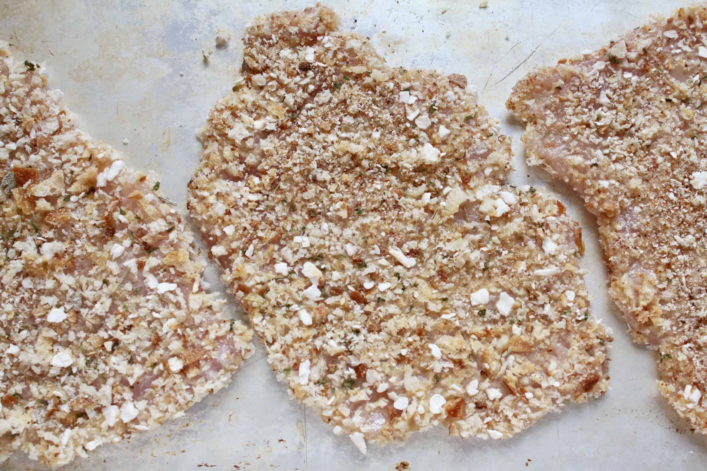 coated cutlets on a tray