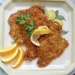 pork schnitzel on a plate with lemon slices