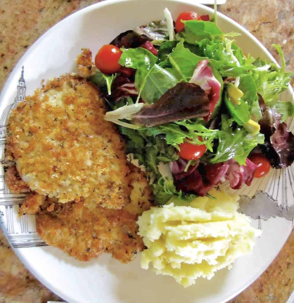 kids breaded pork schnitzel with salad and potatoes