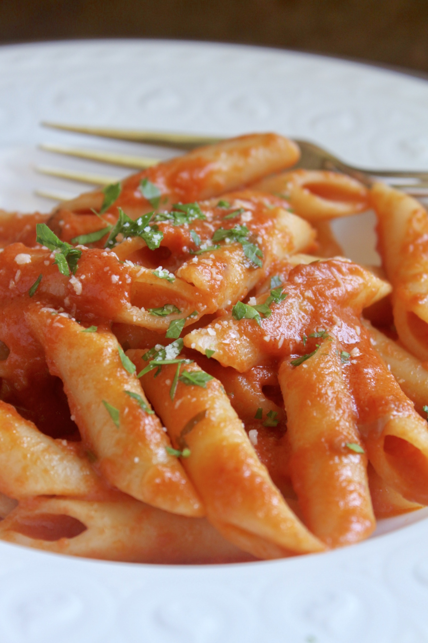 penne alla vodka with cheese in a plate