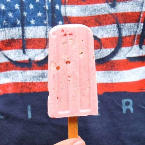 boy holding a popsicle wearing a USA t shirt