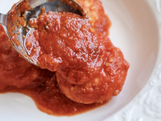 adding sauce over dumpling
