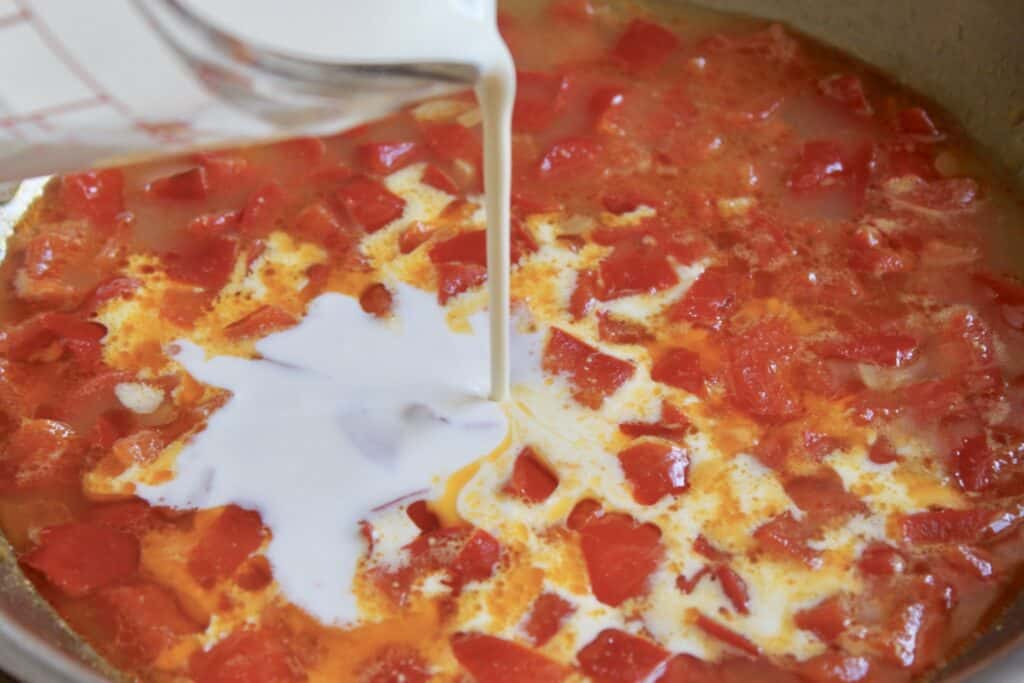 adding cream to pan