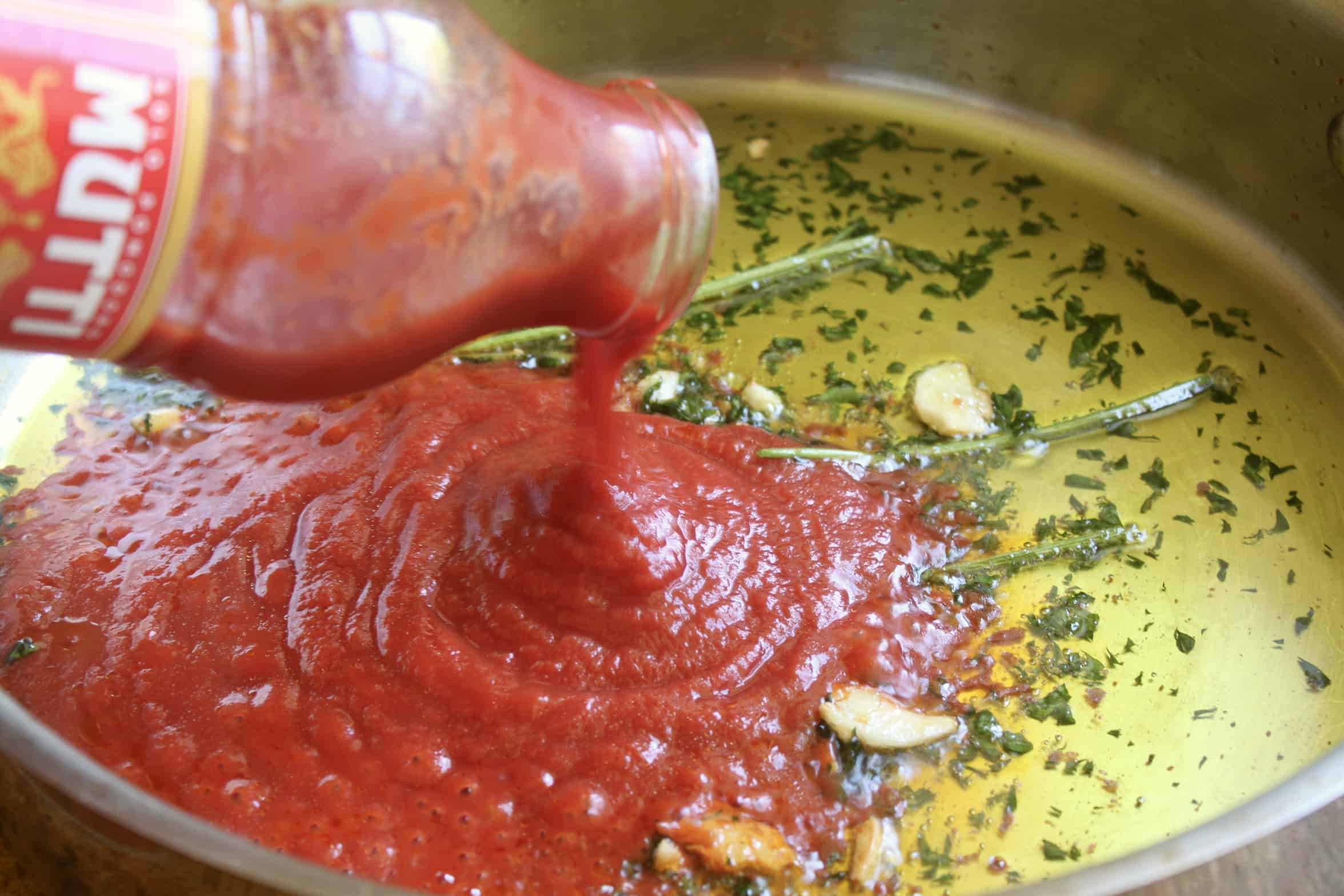 adding passata to the pan