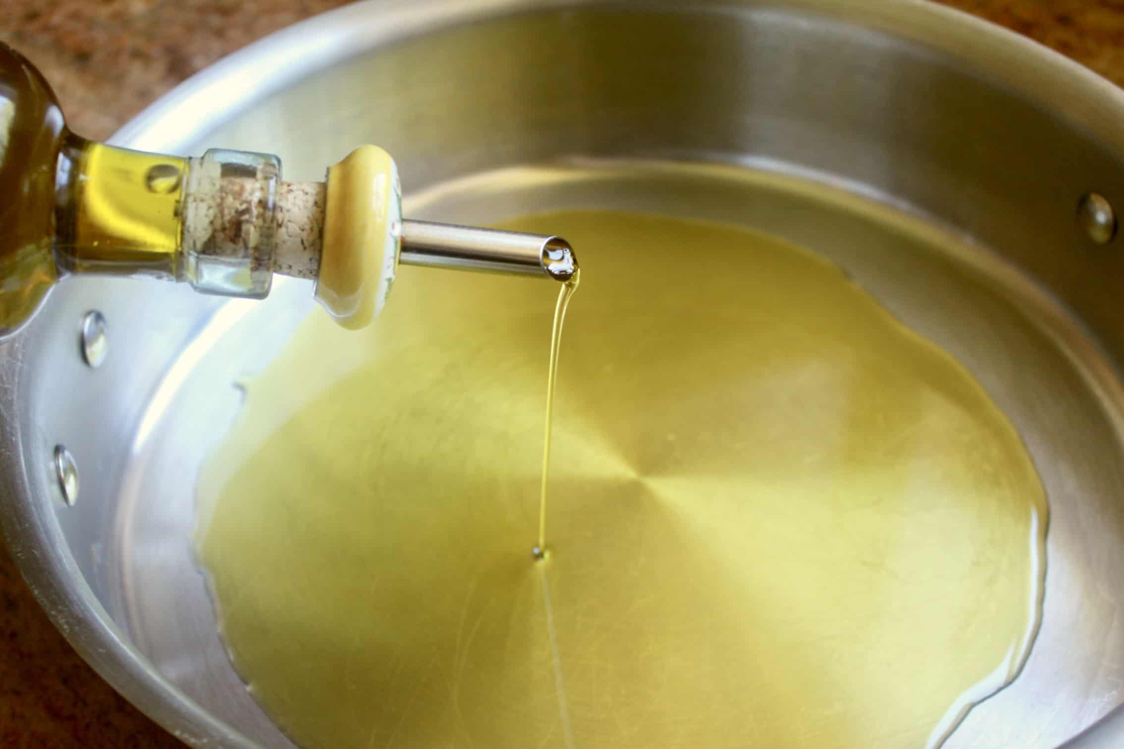 adding oil to a pan