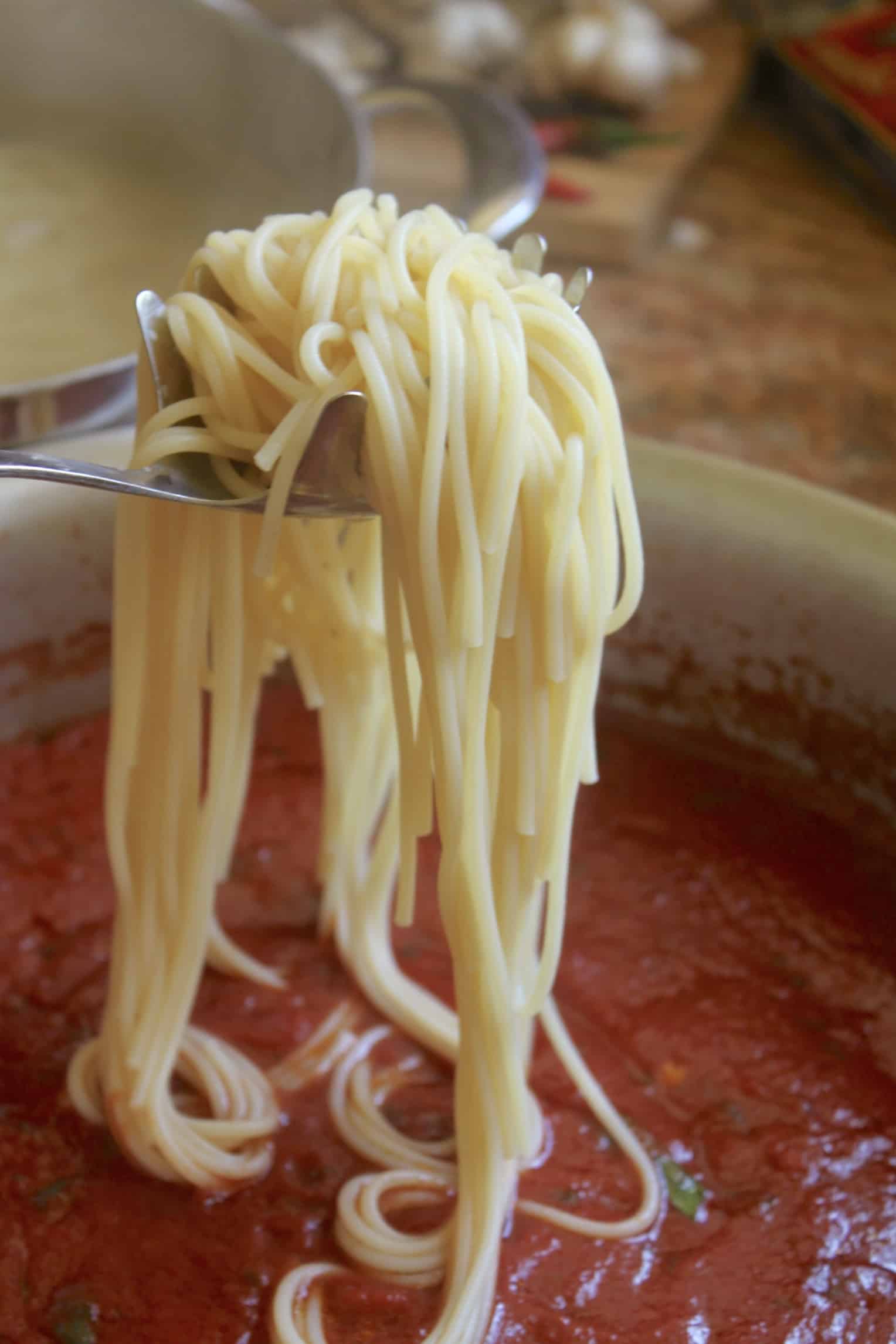 adding spaghetti to the sauce