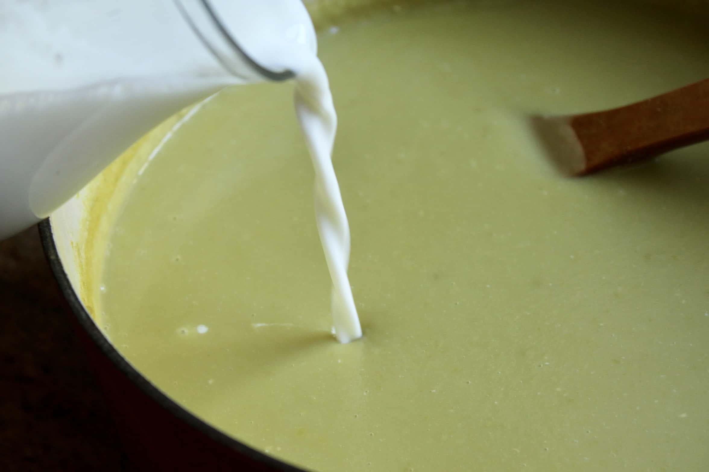 adding cream to soup