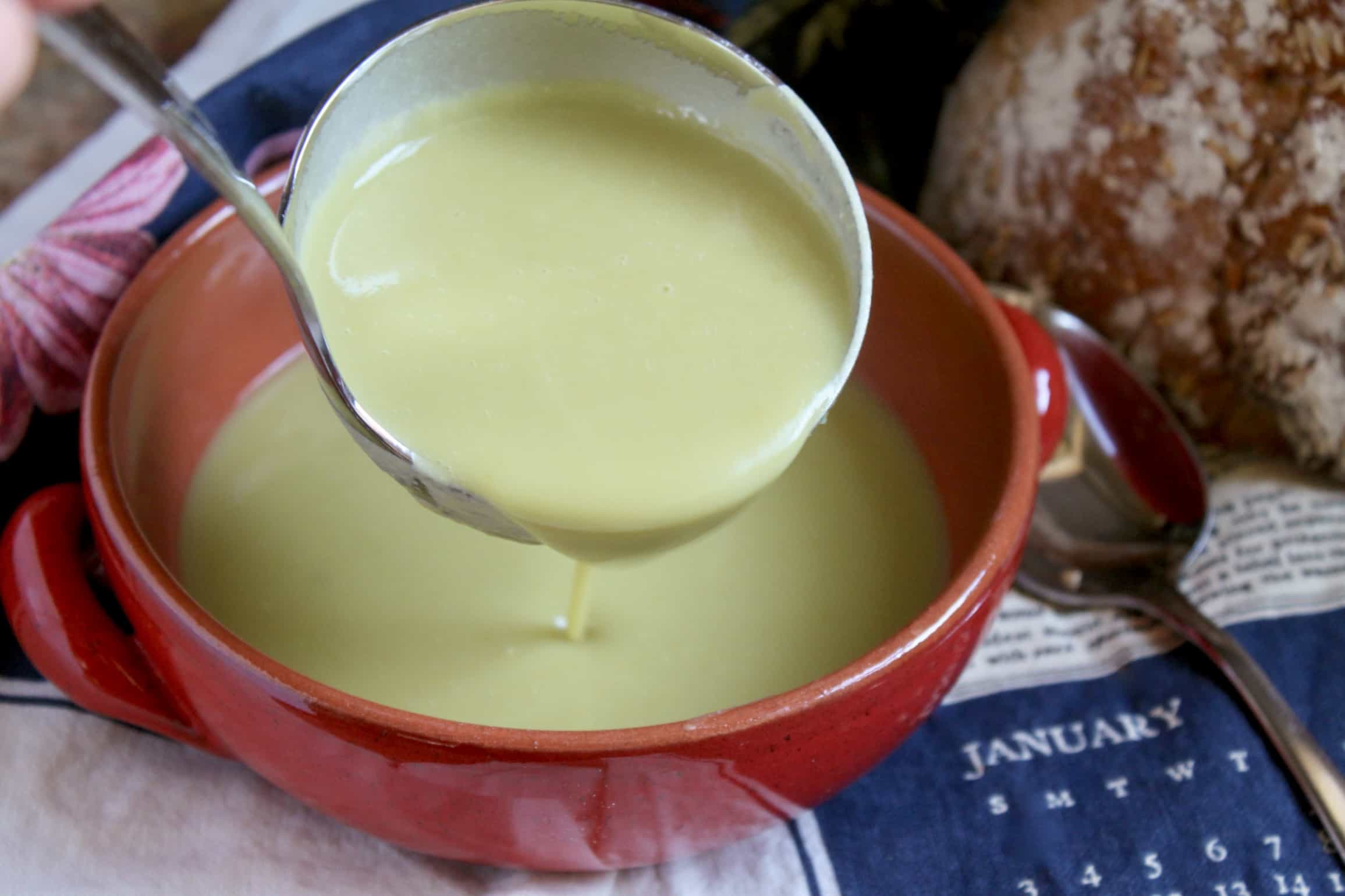 ladling soup into bowl