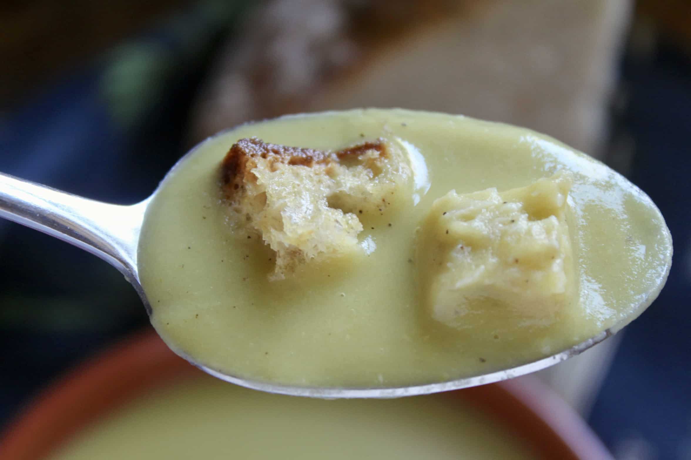 spoonful of pea soup with croutons