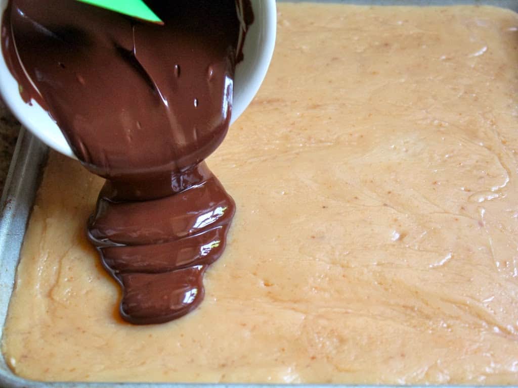 pouring chocolate onto caramel layer 