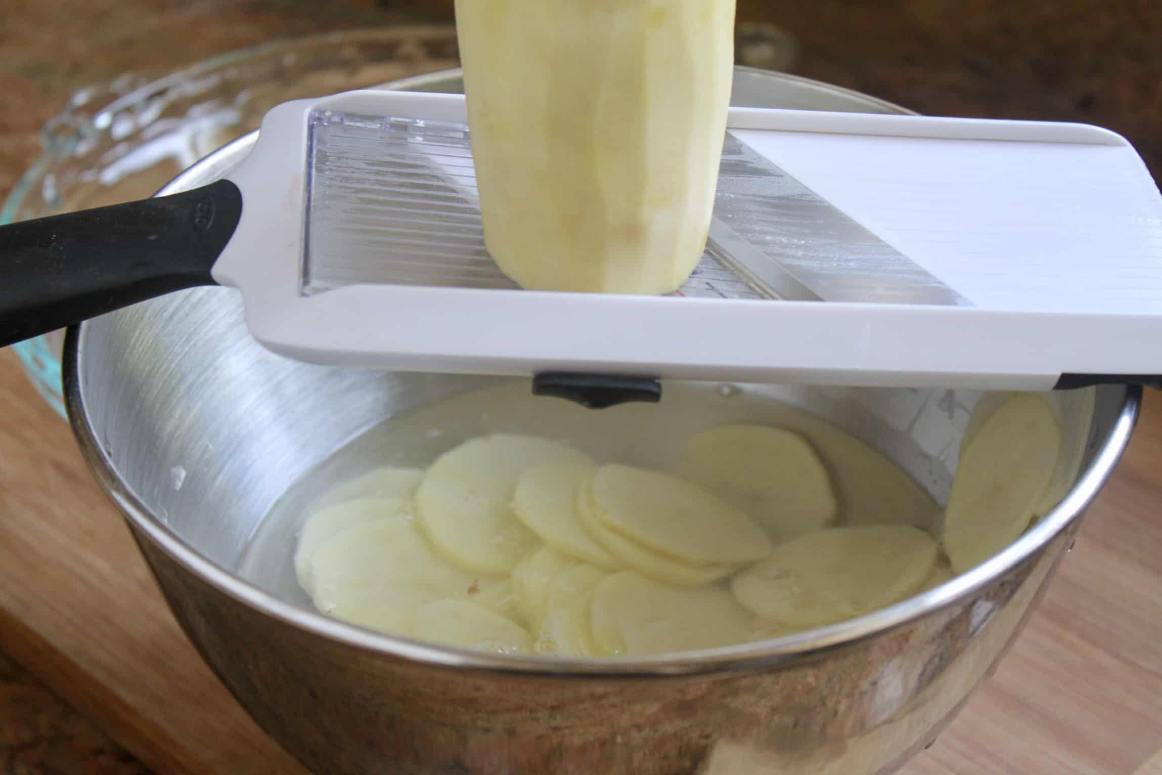 slicing potato with a slicer