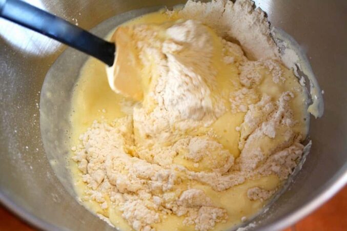 stirring wet and dry ingredients for muffin recipe