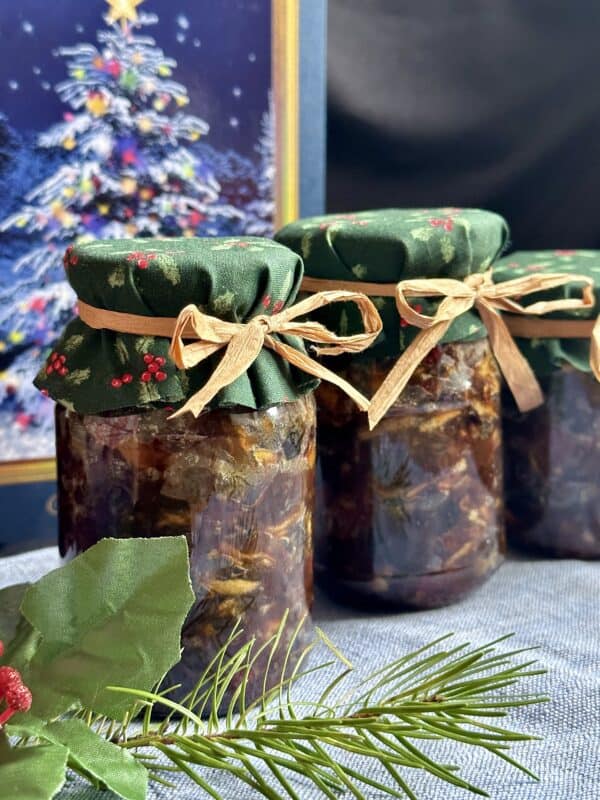 mincemeat in jars with Christmassy decor and a card in back