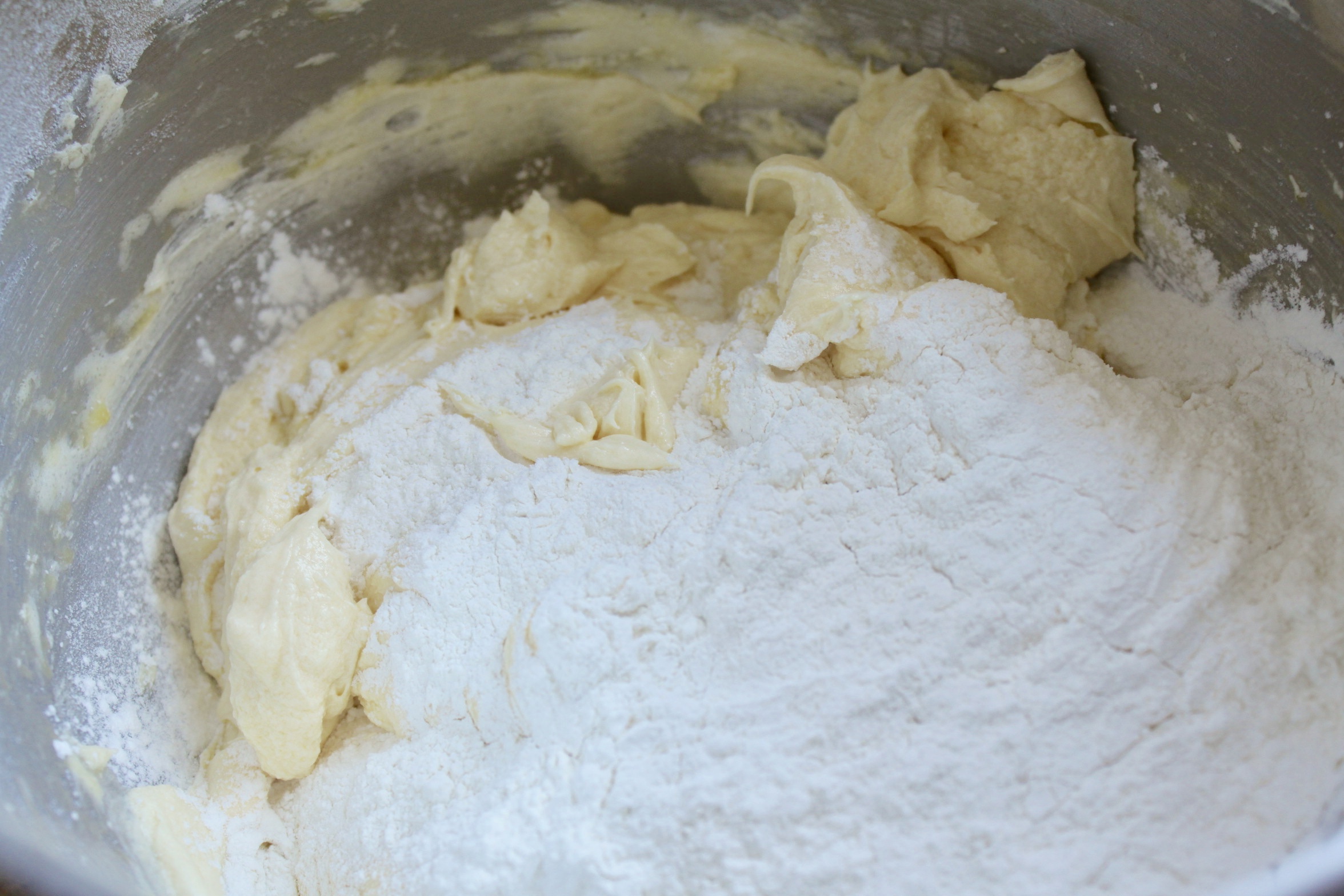 adding flour to batter