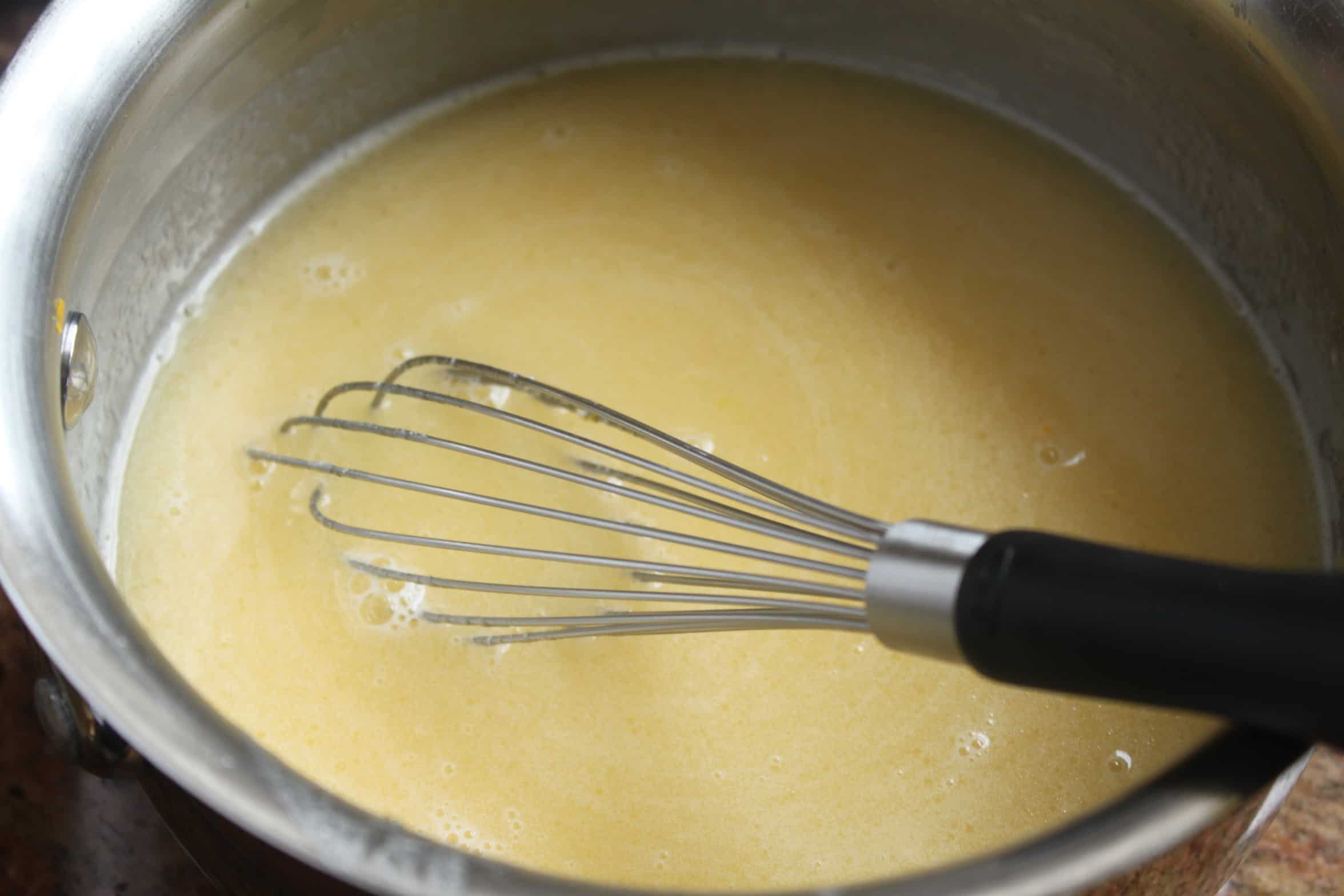 stirring mixture in a pot for pancakes