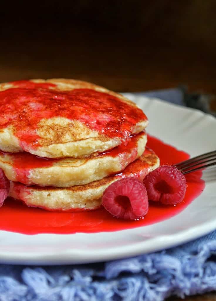 Lemon ricotta Pancakes with raspberries and syrup