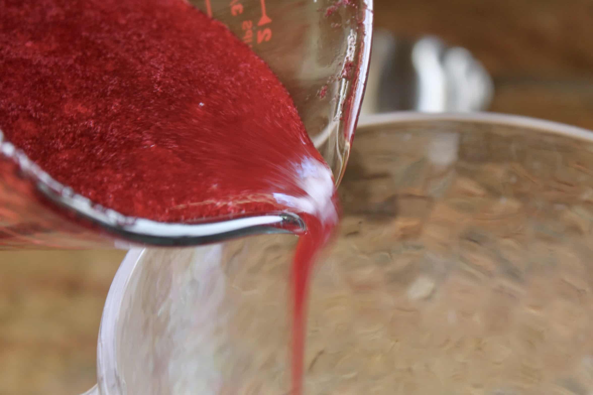 pouring cranberry syrup