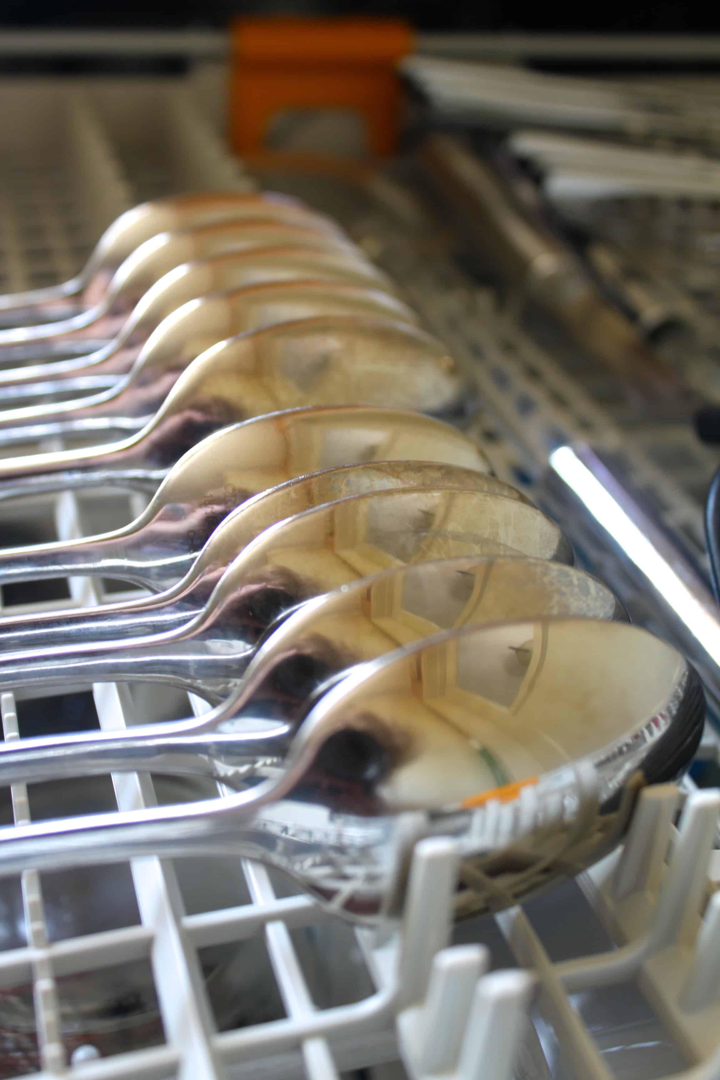 spoons lined up inside the third rack of a Miele dishwasher