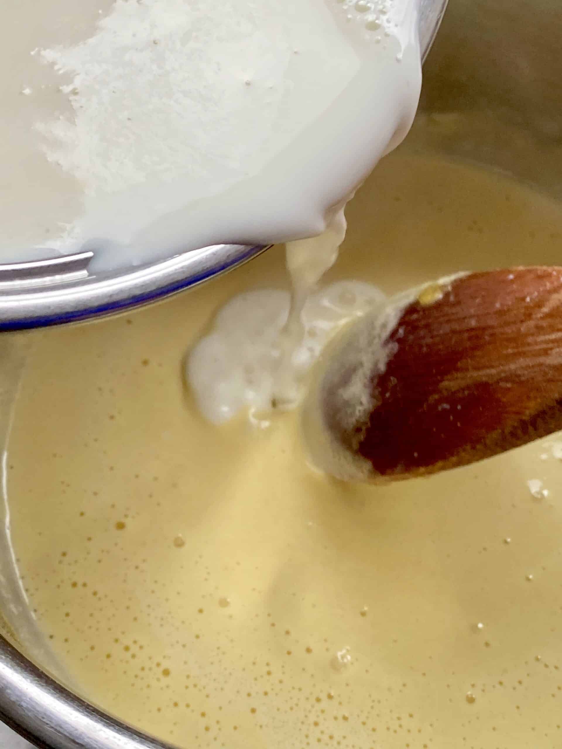 adding milk to pastry cream