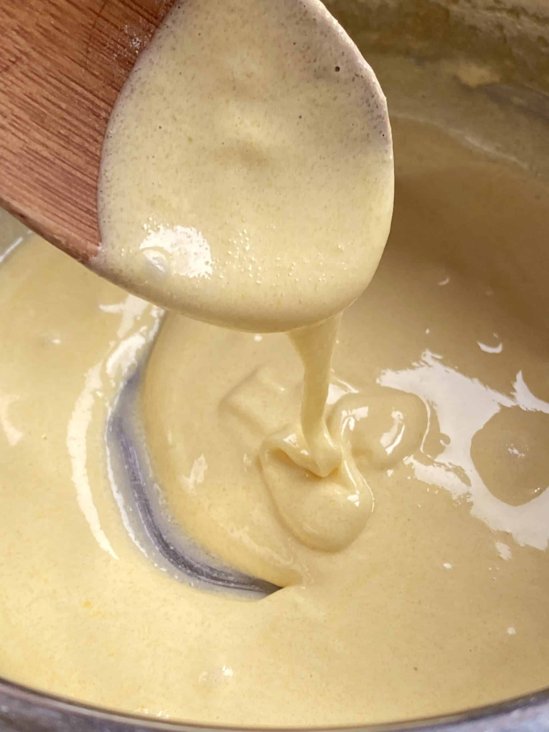 adding milk to pastry cream