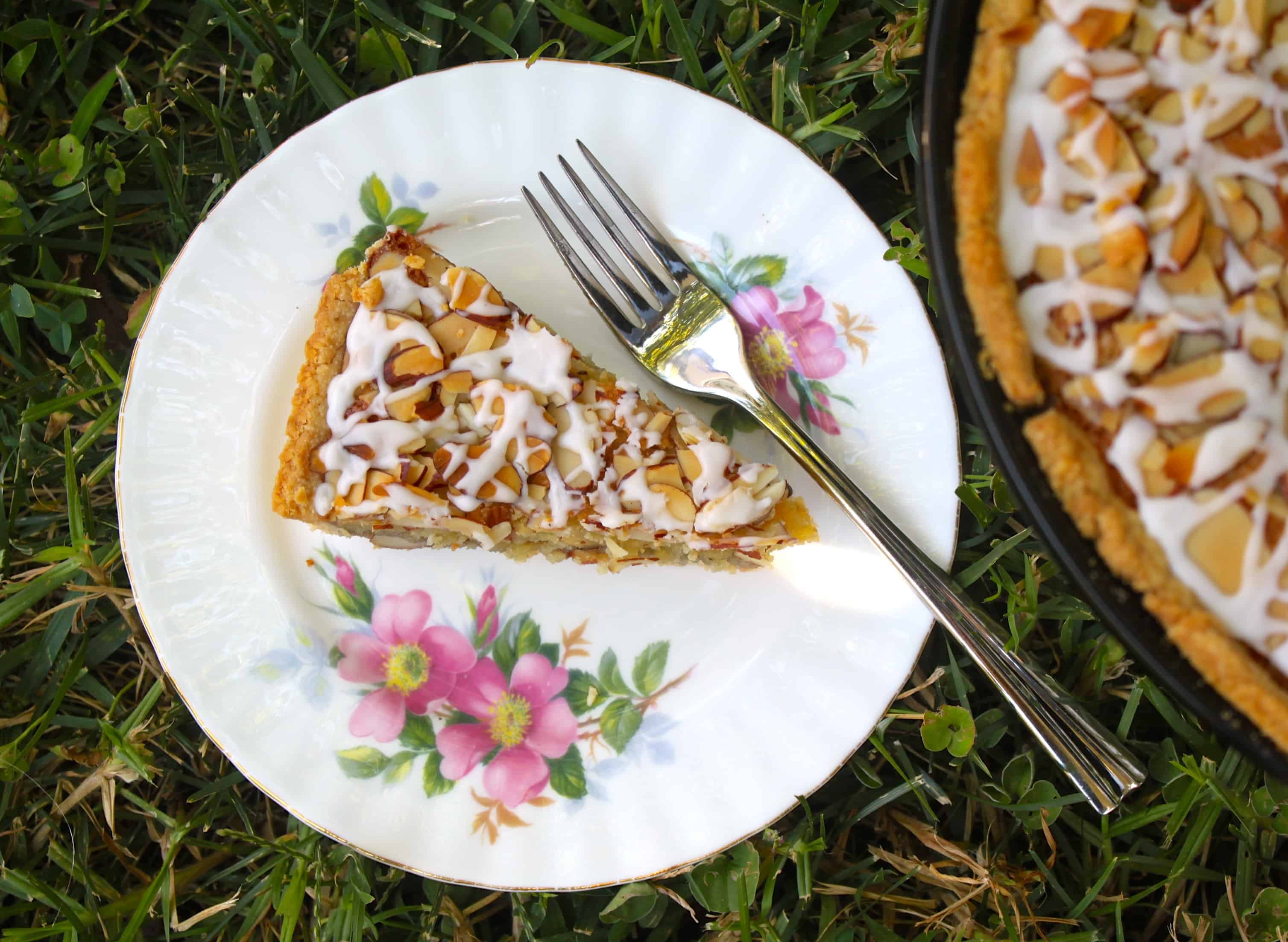 Slice of Bakewell tart on the grass