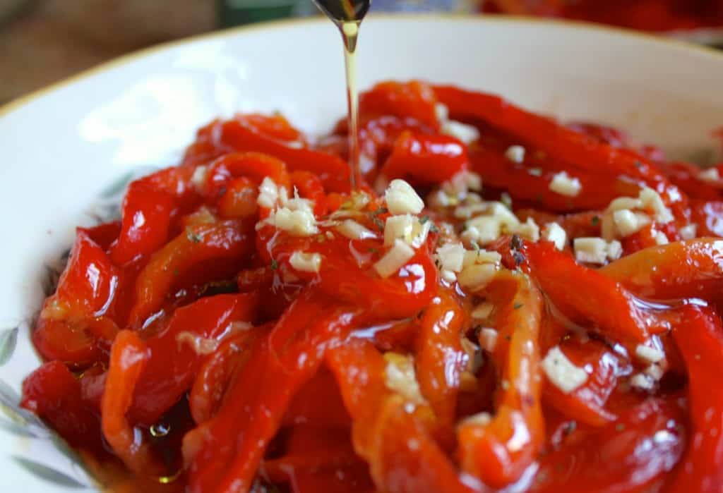 adding oil to roasted red peppers