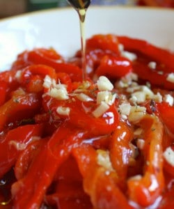 adding oil to roasted red peppers