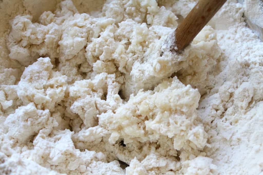 stirring boiling water into flour for authentic Italian gnocchi