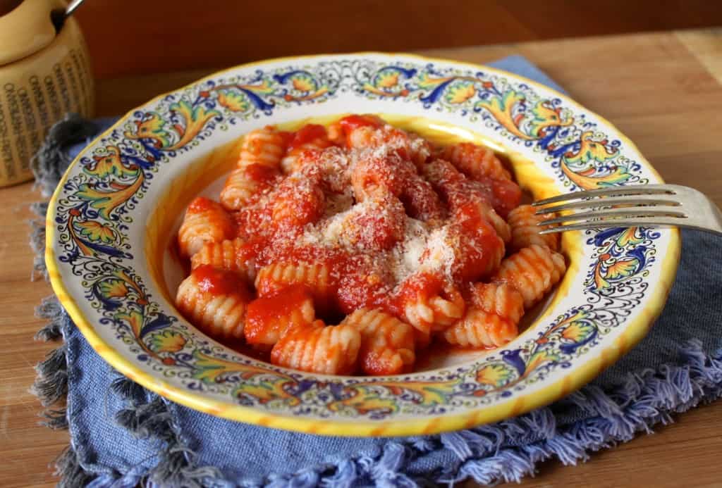 bowl of gnocchi with tomato sauce and cheese