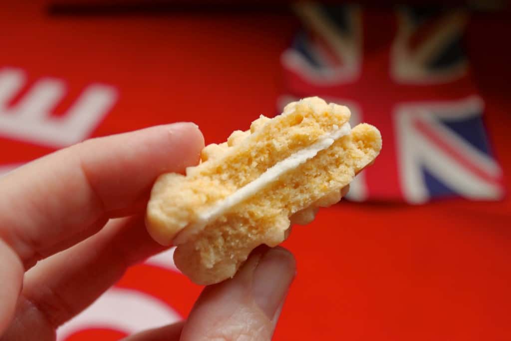 photo of a handheld, half eaten homemade Custard Cream biscuit