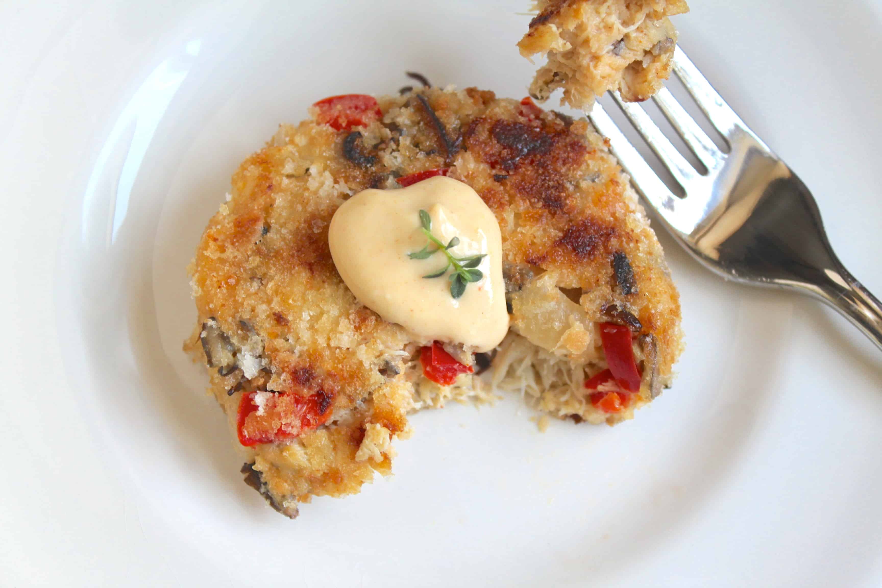 half eaten crab cake on a plate