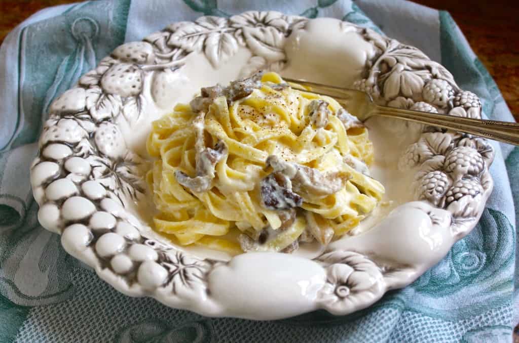 mushroom pasta with a creamy ricotta sauce in a pretty bowl