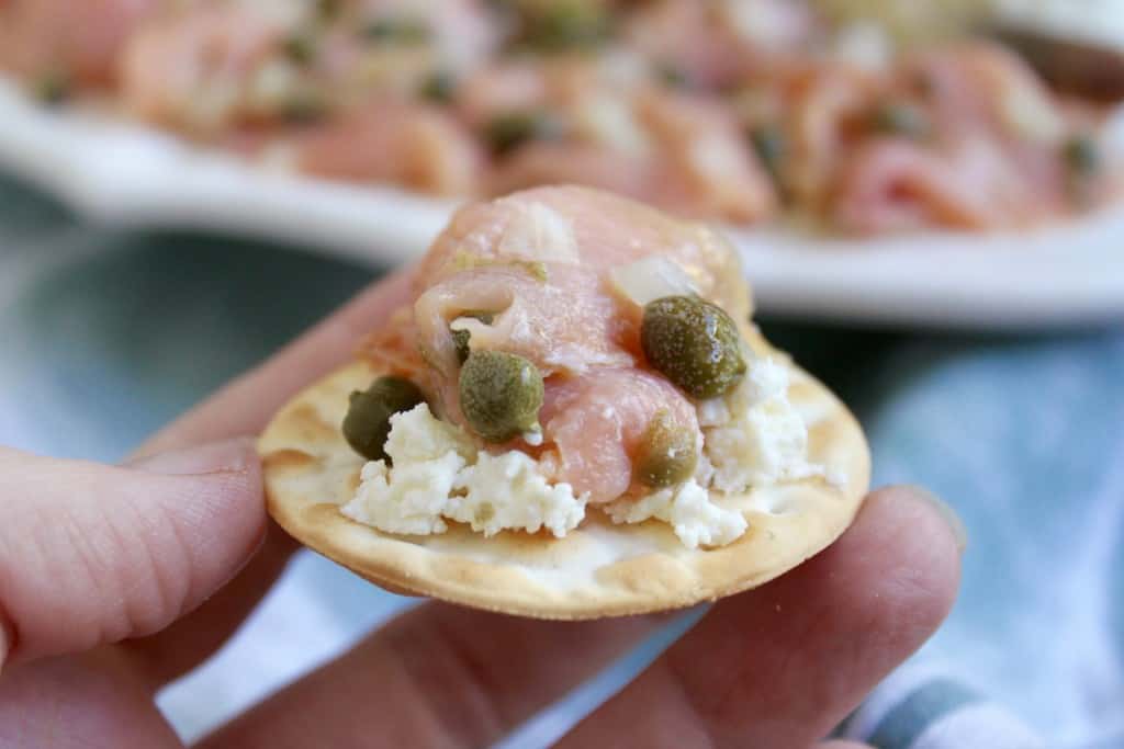 Smoked Salmon and Goat Cheese appetizer in a hand