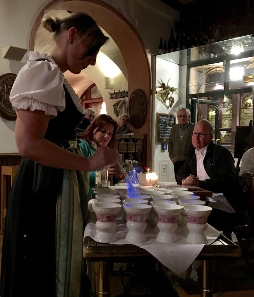 Stirring the flaming brandy in authentic Rüdesheim coffee.