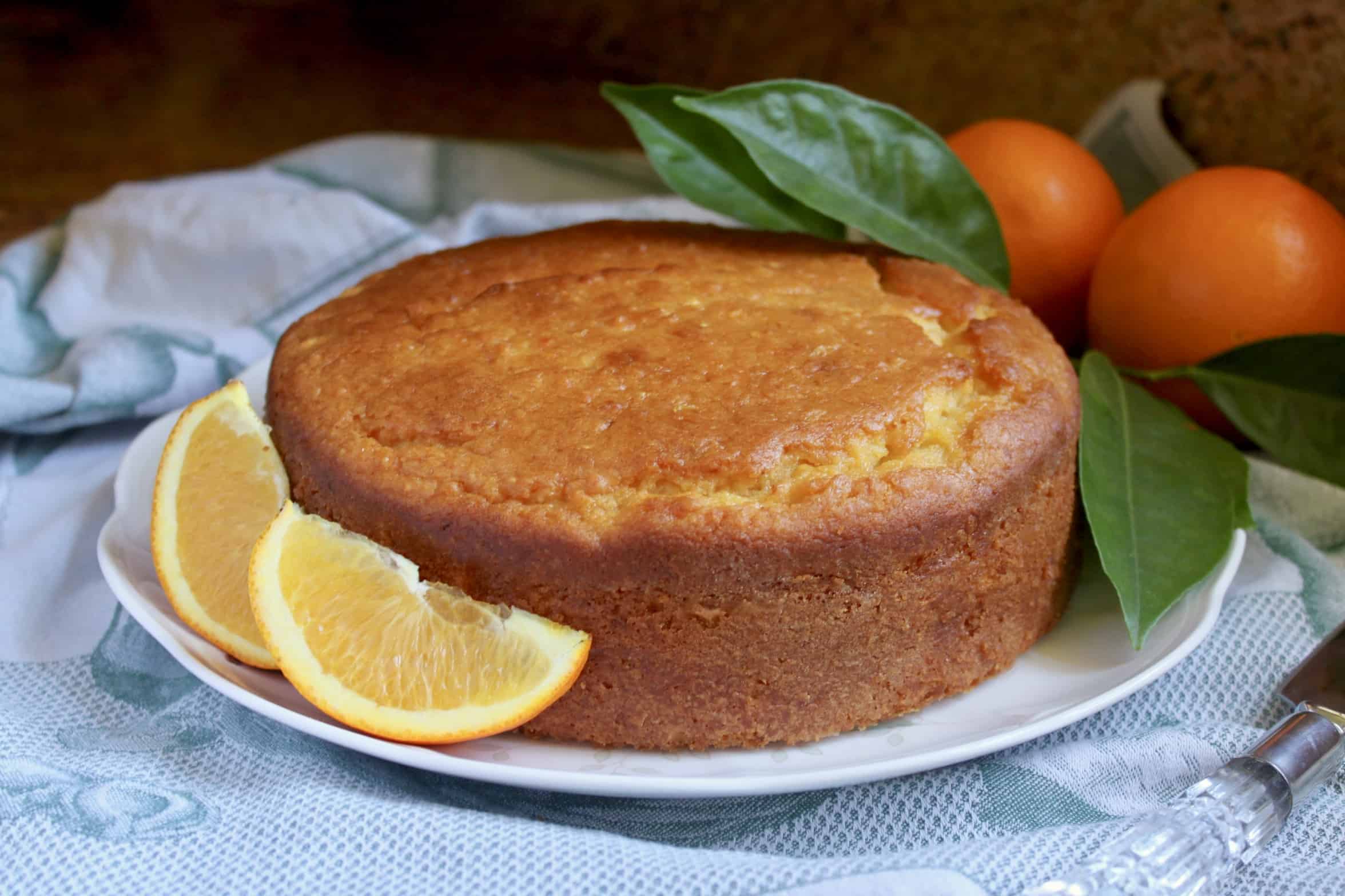 Sicilian Whole Orange cake on a plate with oranges