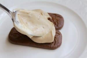 Spooning a layer of Magnum Cream onto cookies