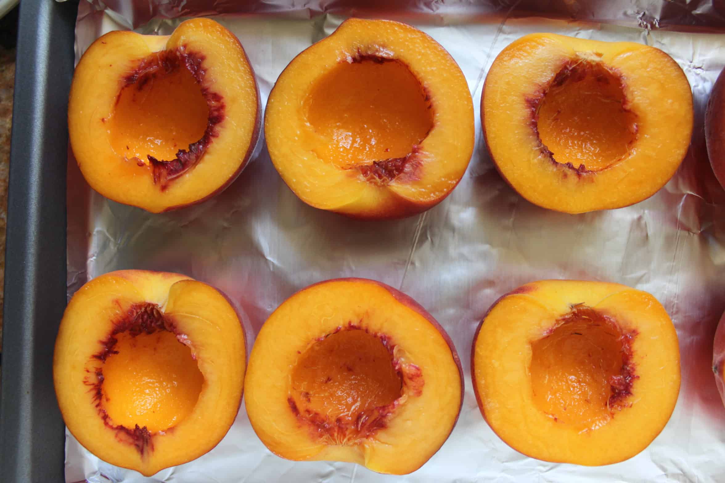 peach halves on a tray