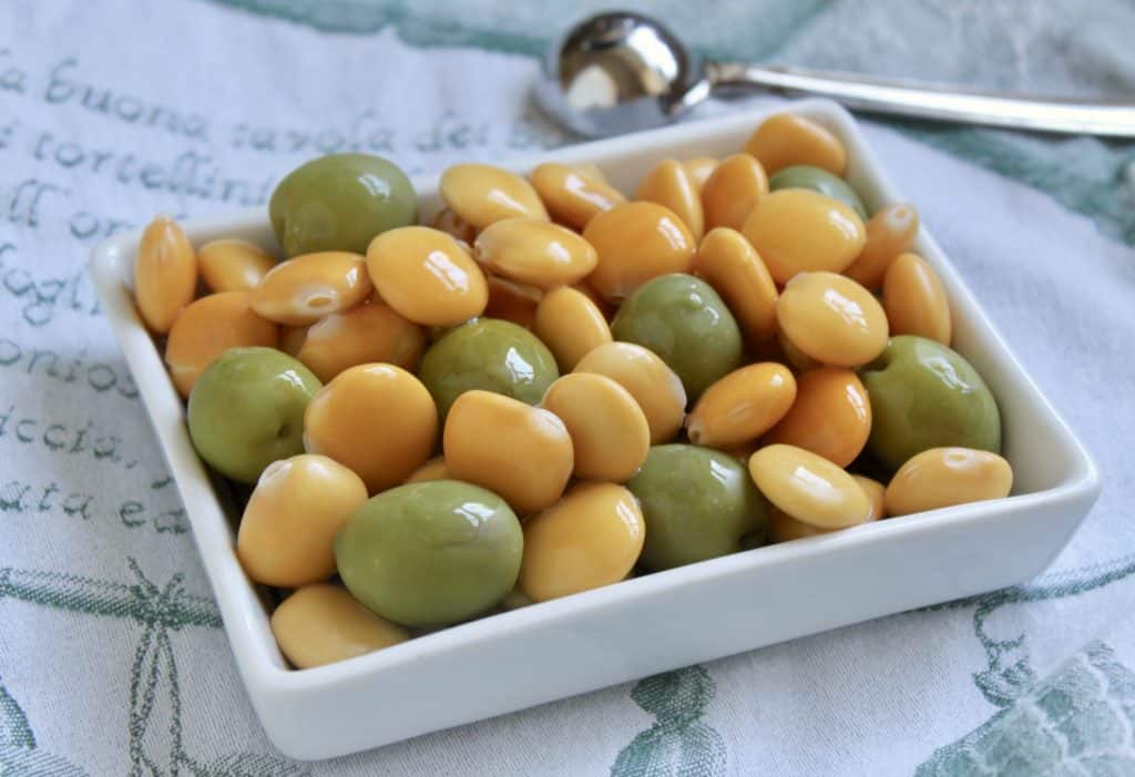 Lupini beans and green olives in a rectangular dish