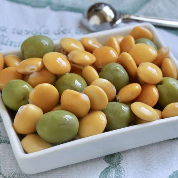 Lupini beans and green olives in a rectangular dish