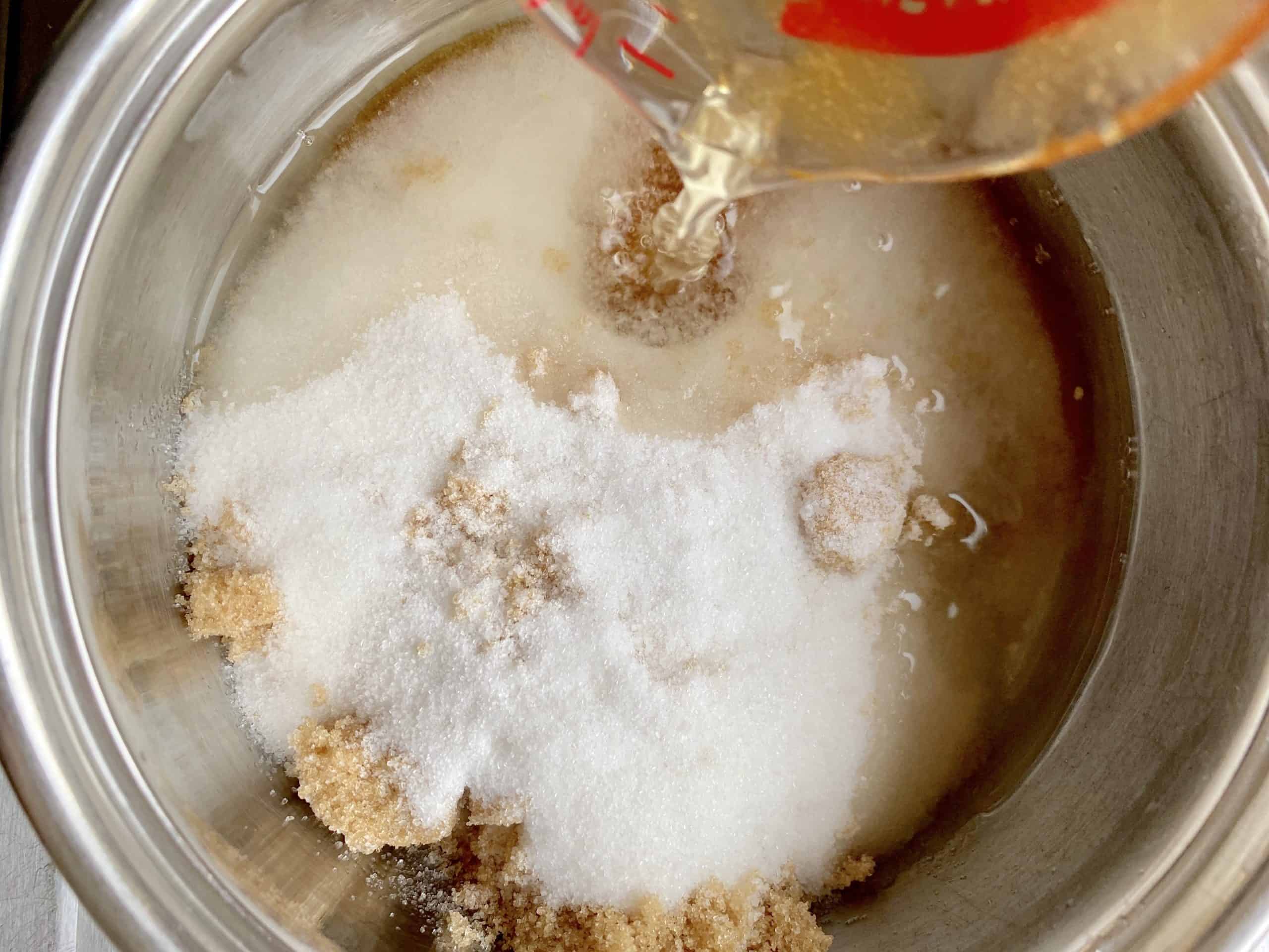 adding water to sugars in a pot