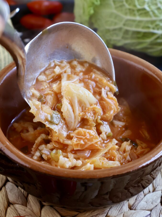 ladling rice and cabbage into bowl