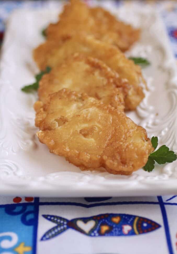 fried baccala on a white tray for Lent