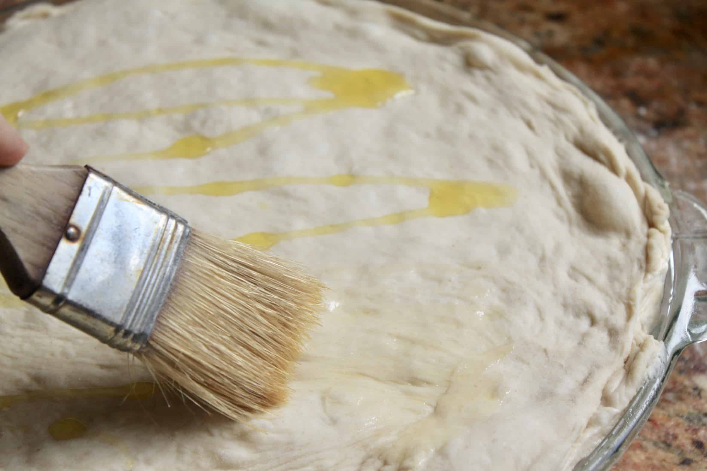 brushing dough with oil