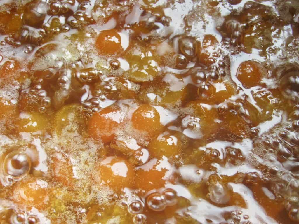 boiling chopped kumquats in a pot