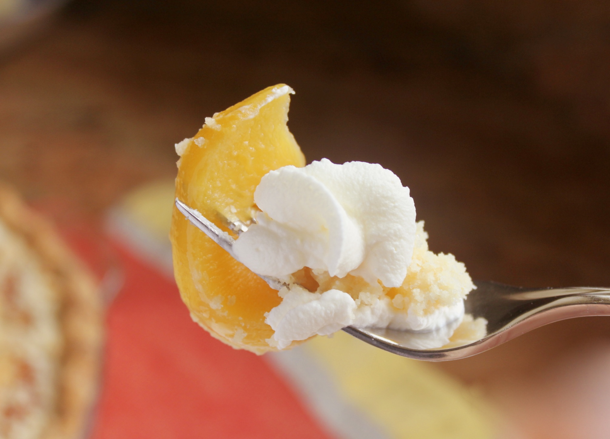 Forkful of custard peach pie and cream