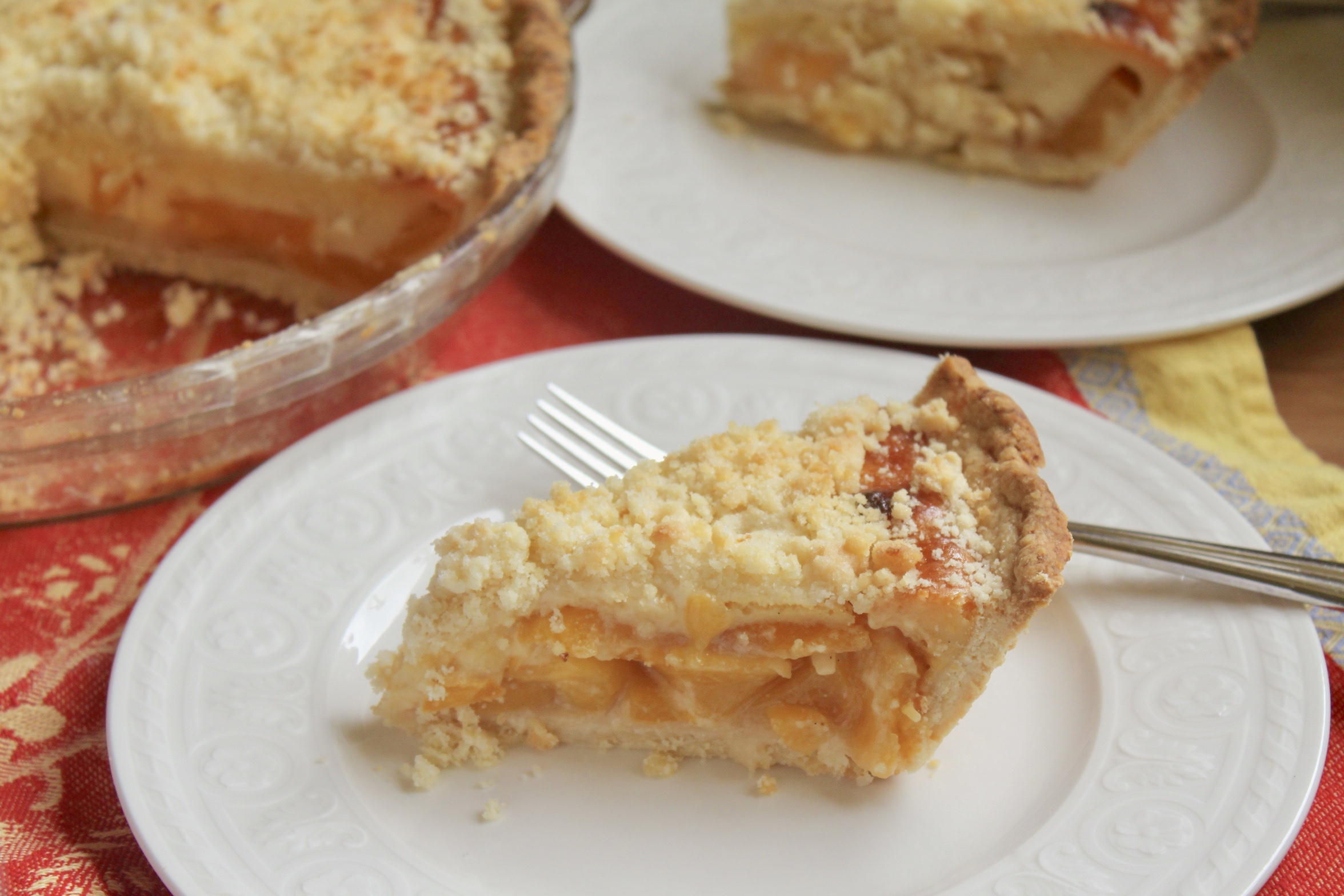 plate with custard peach pie slices