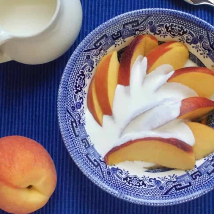 peaches and cream in a blue bowl