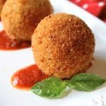 arancini on a plate with basil