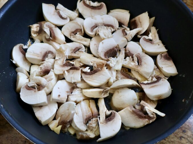 sliced mushrooms in pan